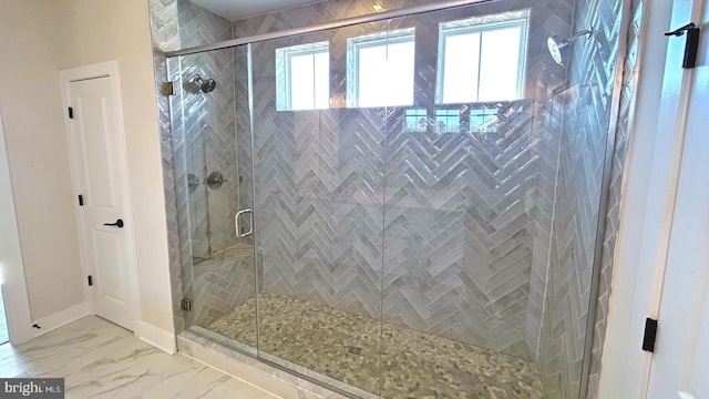 bathroom featuring a shower with door