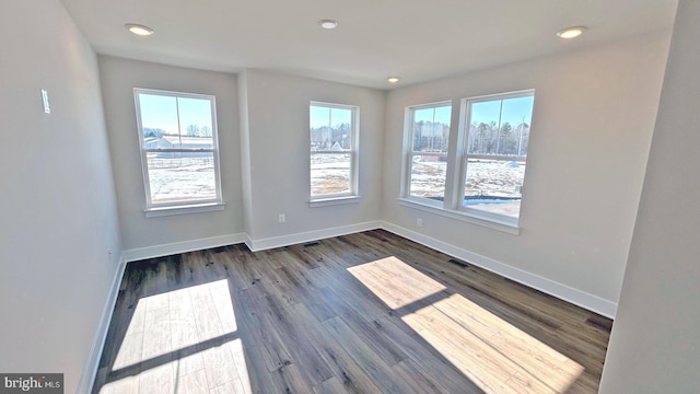 spare room with dark wood-type flooring