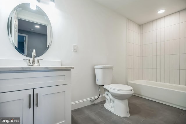 full bathroom featuring vanity, tile patterned flooring, tiled shower / bath, and toilet