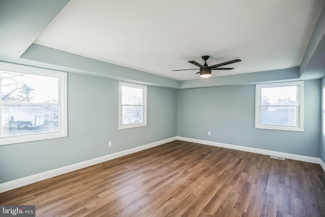 unfurnished room featuring hardwood / wood-style floors, plenty of natural light, and ceiling fan