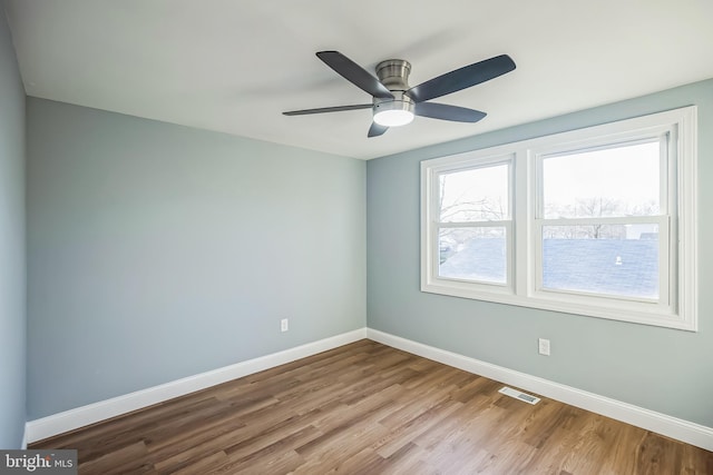 empty room featuring ceiling fan and light hardwood / wood-style flooring