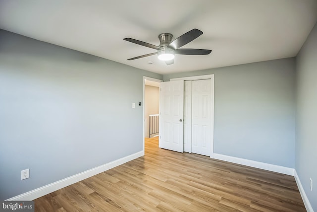 unfurnished bedroom with ceiling fan, light hardwood / wood-style floors, and a closet