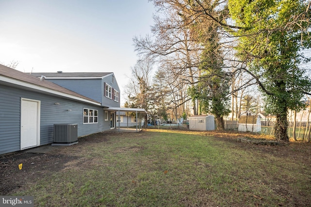 view of yard featuring central AC unit and a storage unit