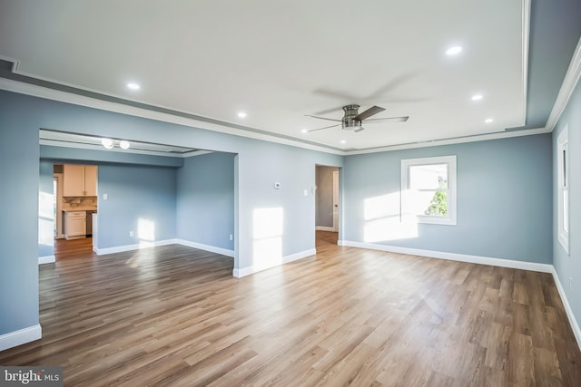 empty room with ceiling fan, light hardwood / wood-style floors, and ornamental molding