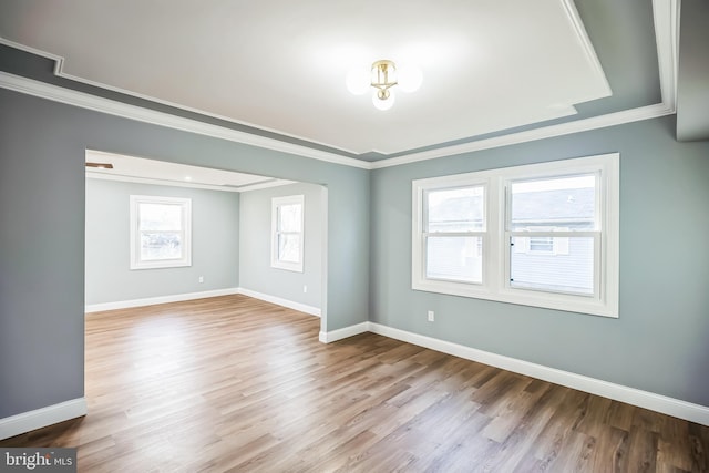 unfurnished room with light hardwood / wood-style floors and crown molding