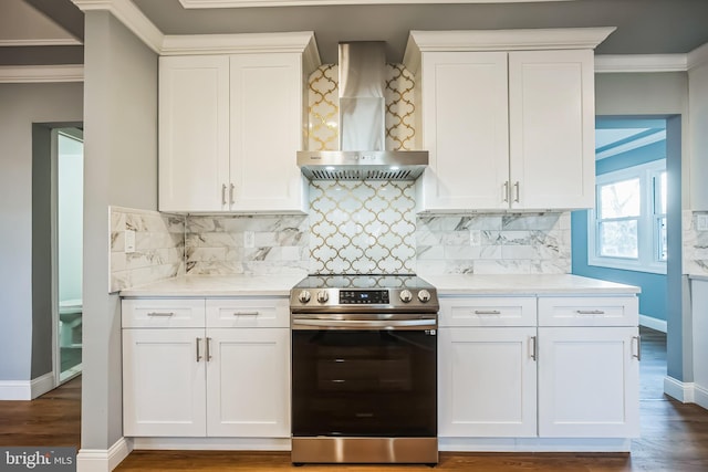 kitchen featuring white cabinetry, stainless steel electric range oven, dark hardwood / wood-style floors, and wall chimney exhaust hood