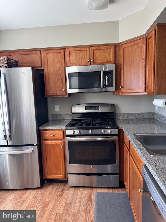 kitchen with stainless steel appliances and light wood-type flooring