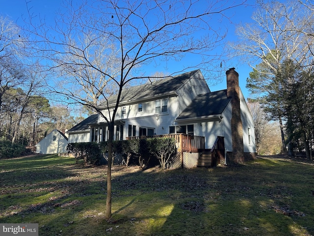 view of home's exterior featuring a deck and a lawn