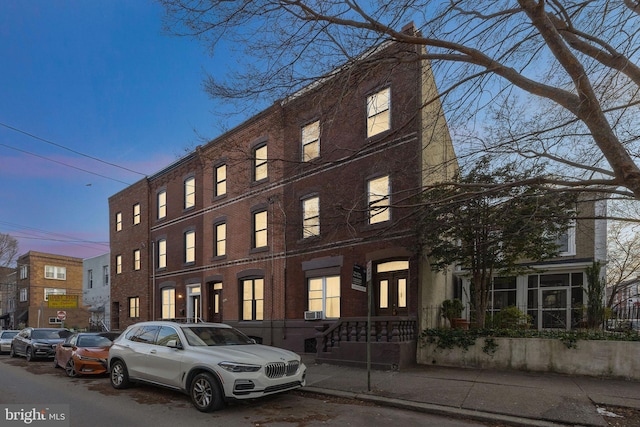 view of outdoor building at dusk