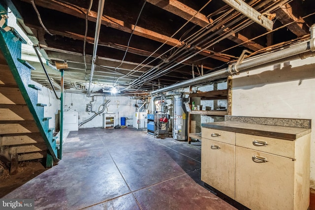 basement featuring water heater and independent washer and dryer