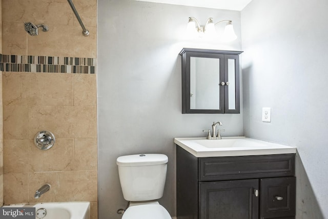 full bathroom featuring vanity, toilet, and tiled shower / bath