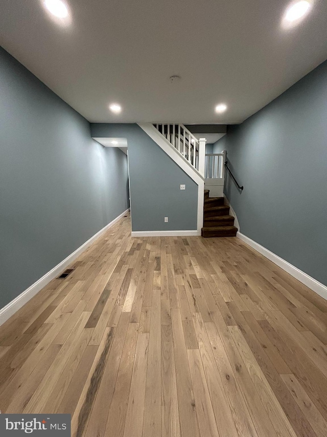 basement with light hardwood / wood-style floors