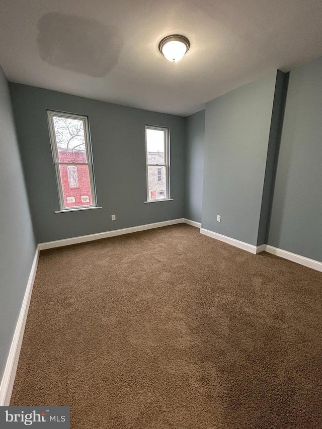 spare room with carpet and plenty of natural light