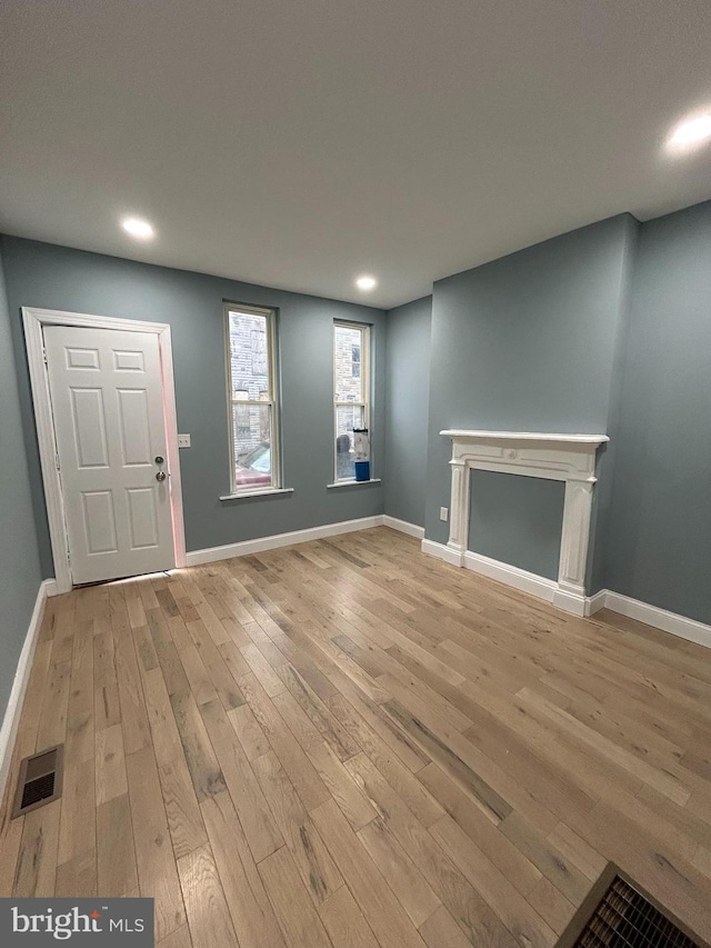 unfurnished living room featuring light wood-type flooring