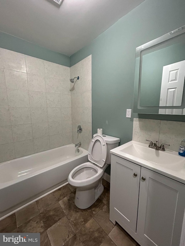 full bathroom featuring vanity, toilet, and tiled shower / bath