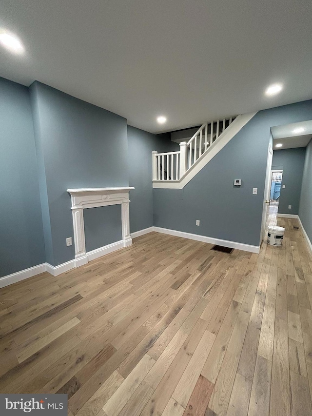 unfurnished living room with light wood-type flooring