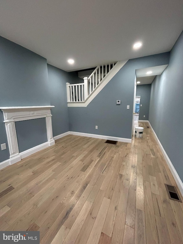 unfurnished living room featuring light hardwood / wood-style floors