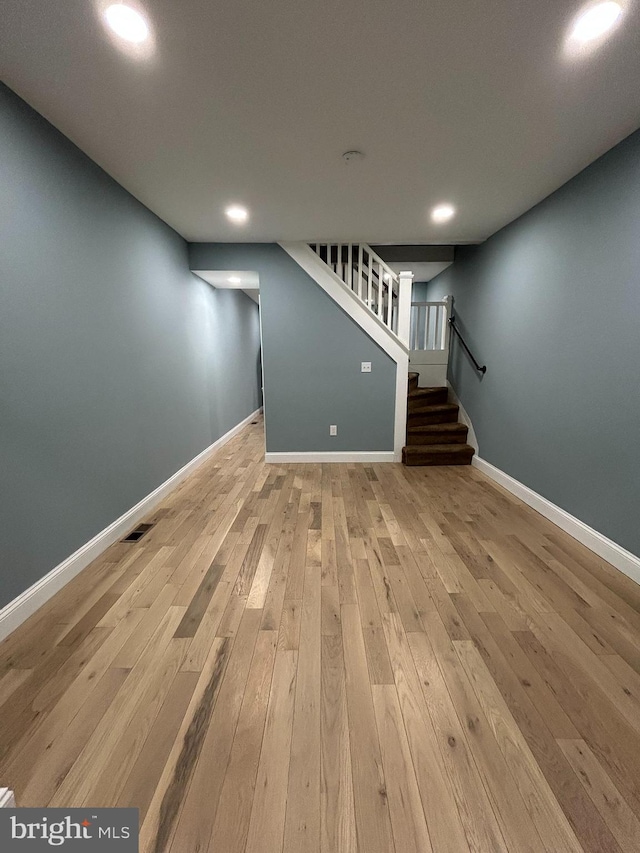 basement featuring light hardwood / wood-style floors