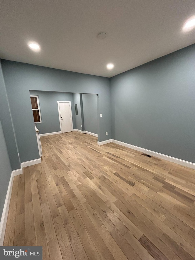 spare room with light hardwood / wood-style flooring