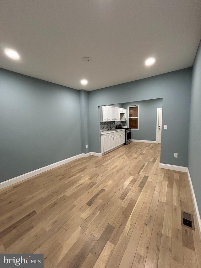 unfurnished living room with light wood-type flooring