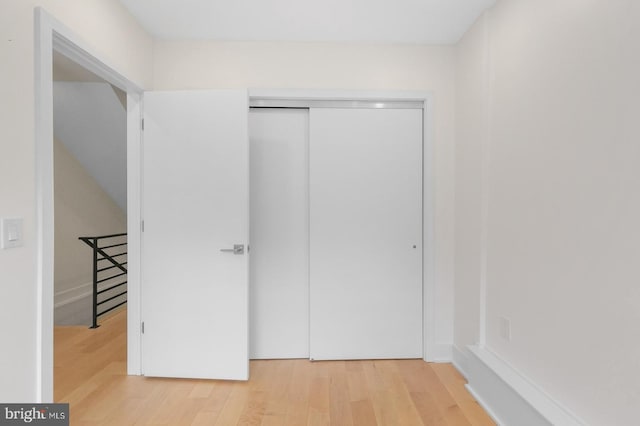 unfurnished bedroom with a closet and hardwood / wood-style floors