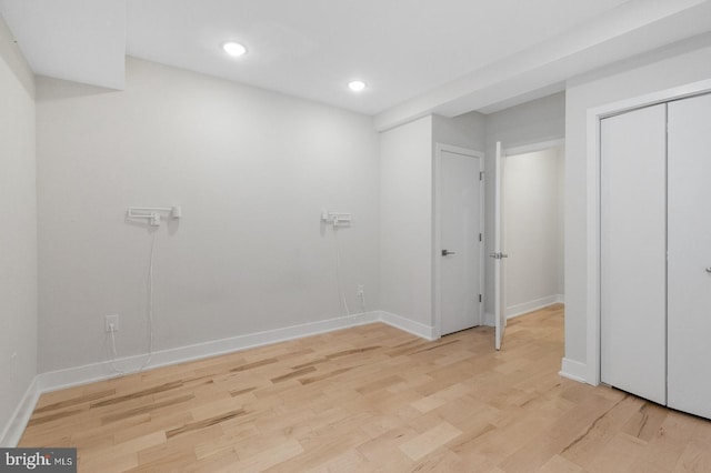 unfurnished bedroom with a closet and light hardwood / wood-style flooring