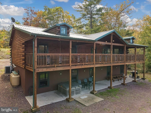 back of property featuring a patio area, cooling unit, and a wooden deck