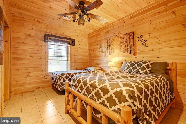 tiled bedroom with ceiling fan, wood ceiling, and wooden walls