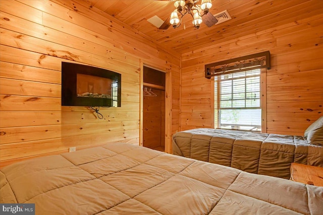 unfurnished bedroom with a closet, wooden walls, and wood ceiling