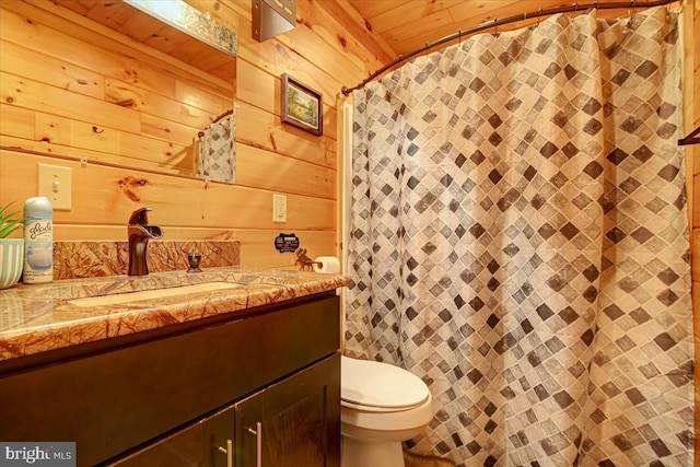 bathroom with wooden walls, vanity, wood ceiling, and toilet