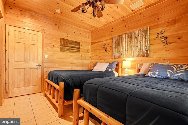 tiled bedroom with ceiling fan, wooden ceiling, and wood walls