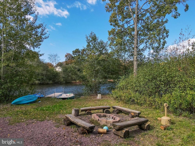 view of yard with a boat dock and a water view