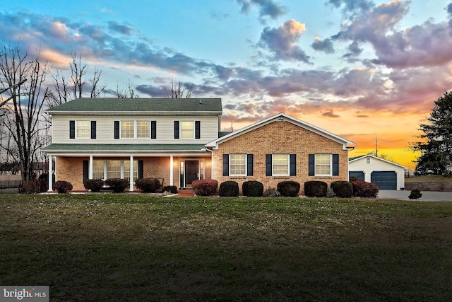 view of front of house with an outbuilding, a yard, and a garage