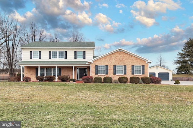 front facade with a front yard, an outdoor structure, and a garage