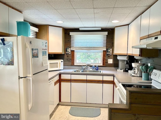 kitchen with sink, white cabinets, a drop ceiling, and white appliances