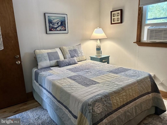 bedroom featuring hardwood / wood-style floors and cooling unit