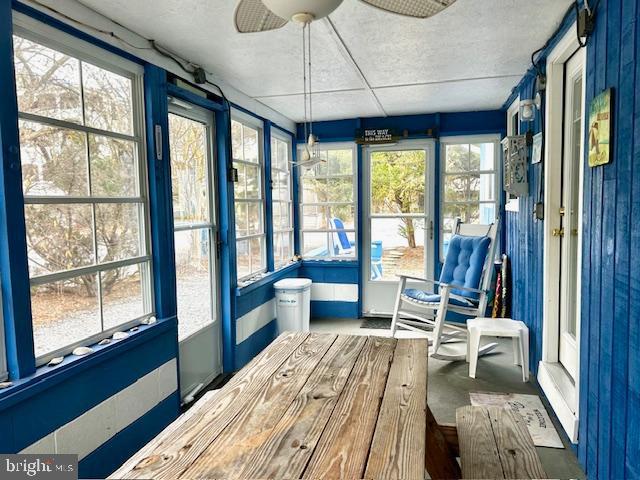 sunroom with ceiling fan and a healthy amount of sunlight