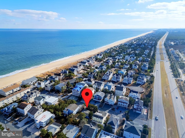 birds eye view of property featuring a view of the beach and a water view