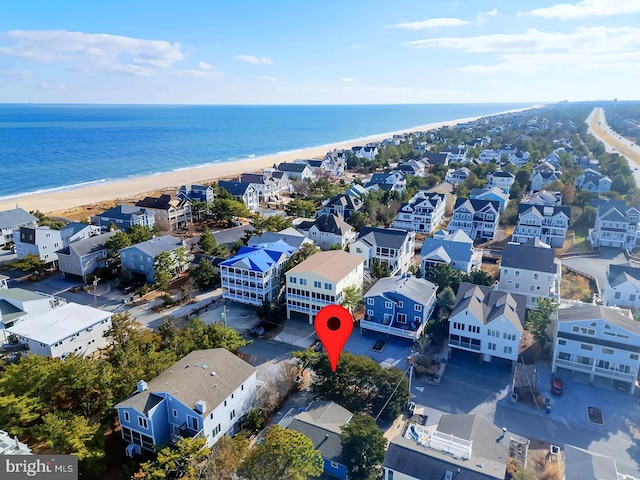 bird's eye view featuring a view of the beach and a water view