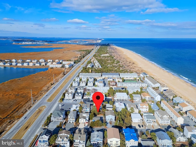 birds eye view of property featuring a water view and a view of the beach