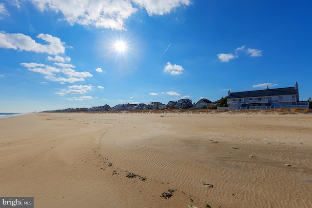 exterior space featuring a view of the beach and a water view