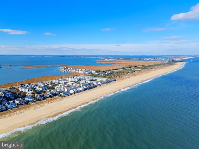 bird's eye view featuring a water view and a beach view