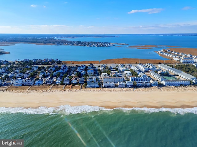 drone / aerial view with a water view and a beach view