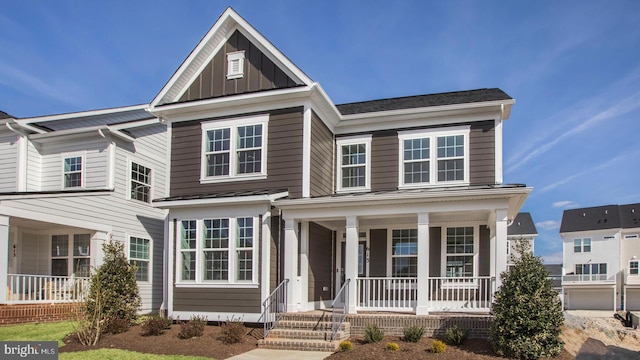 traditional-style home featuring board and batten siding, covered porch, metal roof, and a standing seam roof