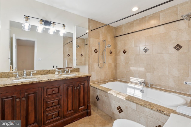 bathroom with tile patterned flooring, vanity, and tiled shower / bath