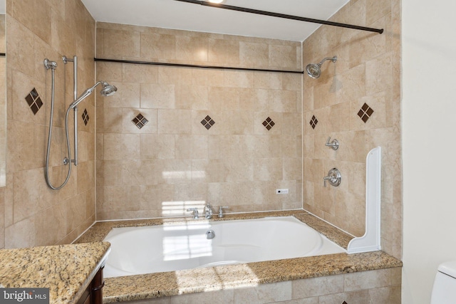 full bathroom featuring vanity, toilet, and tiled shower / bath