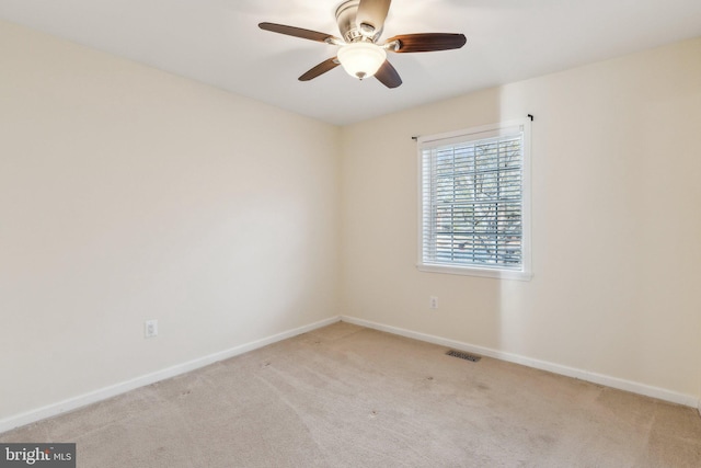 unfurnished room with ceiling fan and light carpet