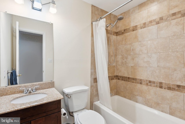 full bathroom with shower / bath combo, vanity, and toilet