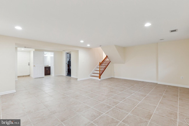 basement featuring light tile patterned floors