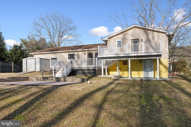 view of front of house with a storage unit, a front yard, a patio area, and a wooden deck